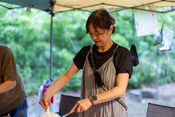 Senior couple cooking in camp